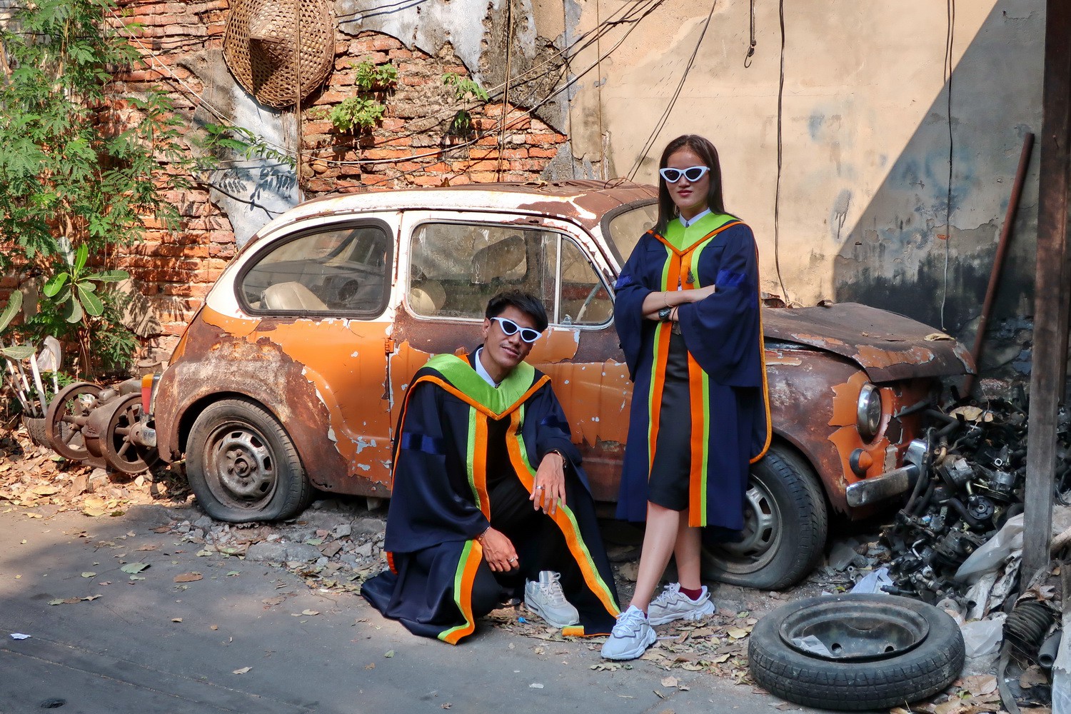 Two students with an old car